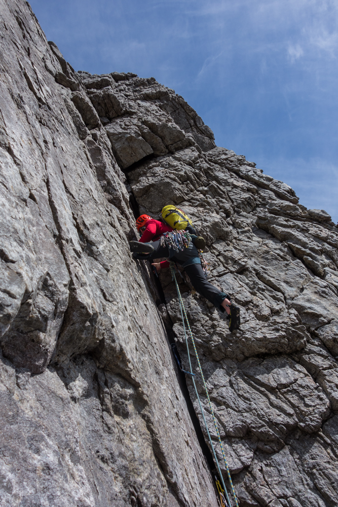 Joe begins to bridge his way up the outrageous corner, shuffling our biggest cam up the wide crack