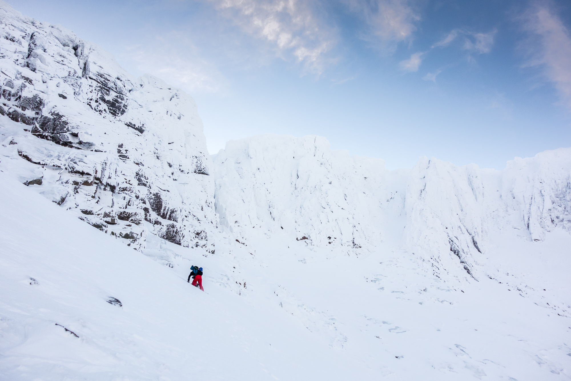 Andy slogging up to the convenient gearing up spot; where the wind had sculpted a perfect flat ledge.