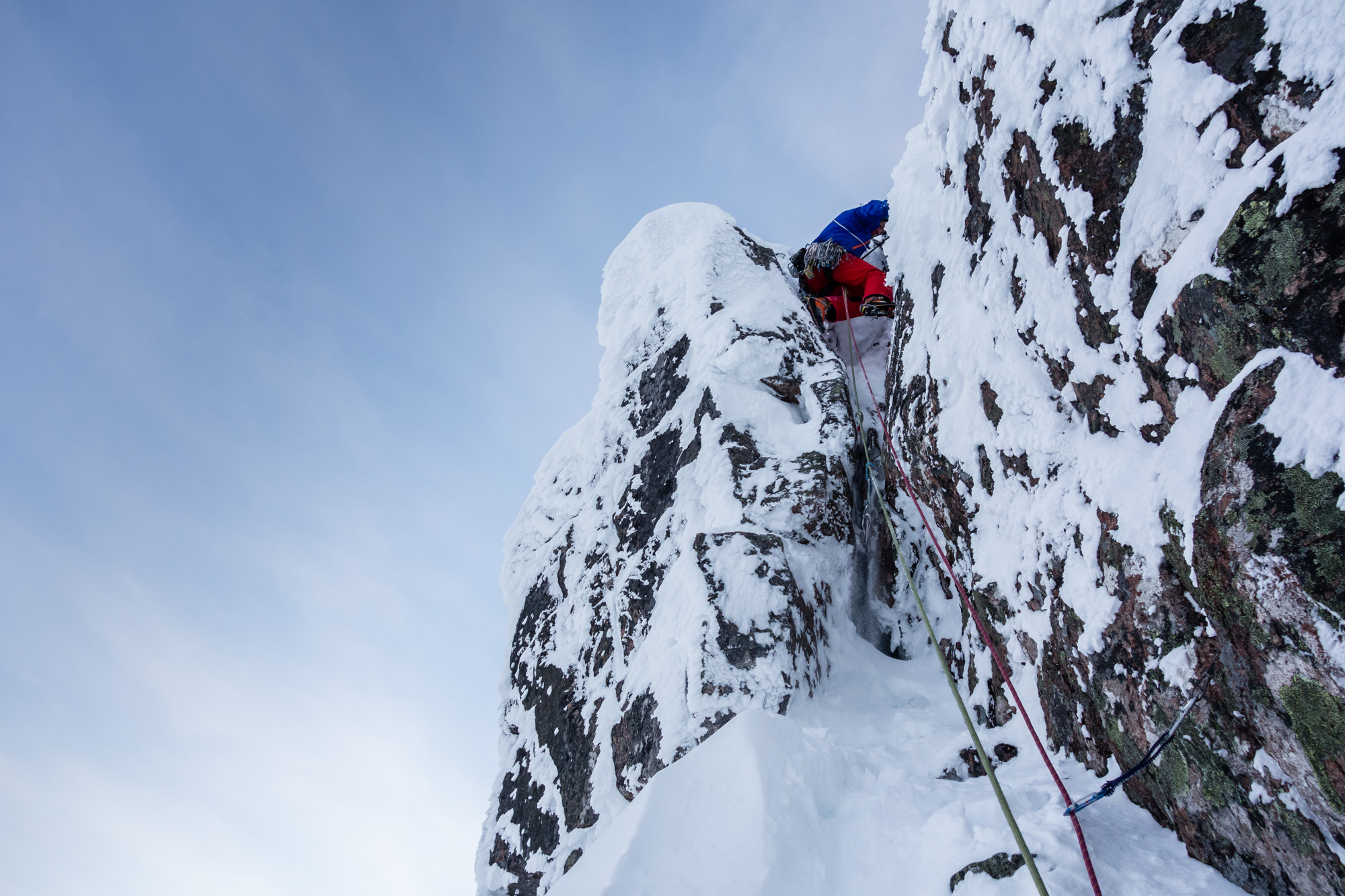 Andy back-and-footing to exit the short chimney at the start of the route - a good introductory pitch.