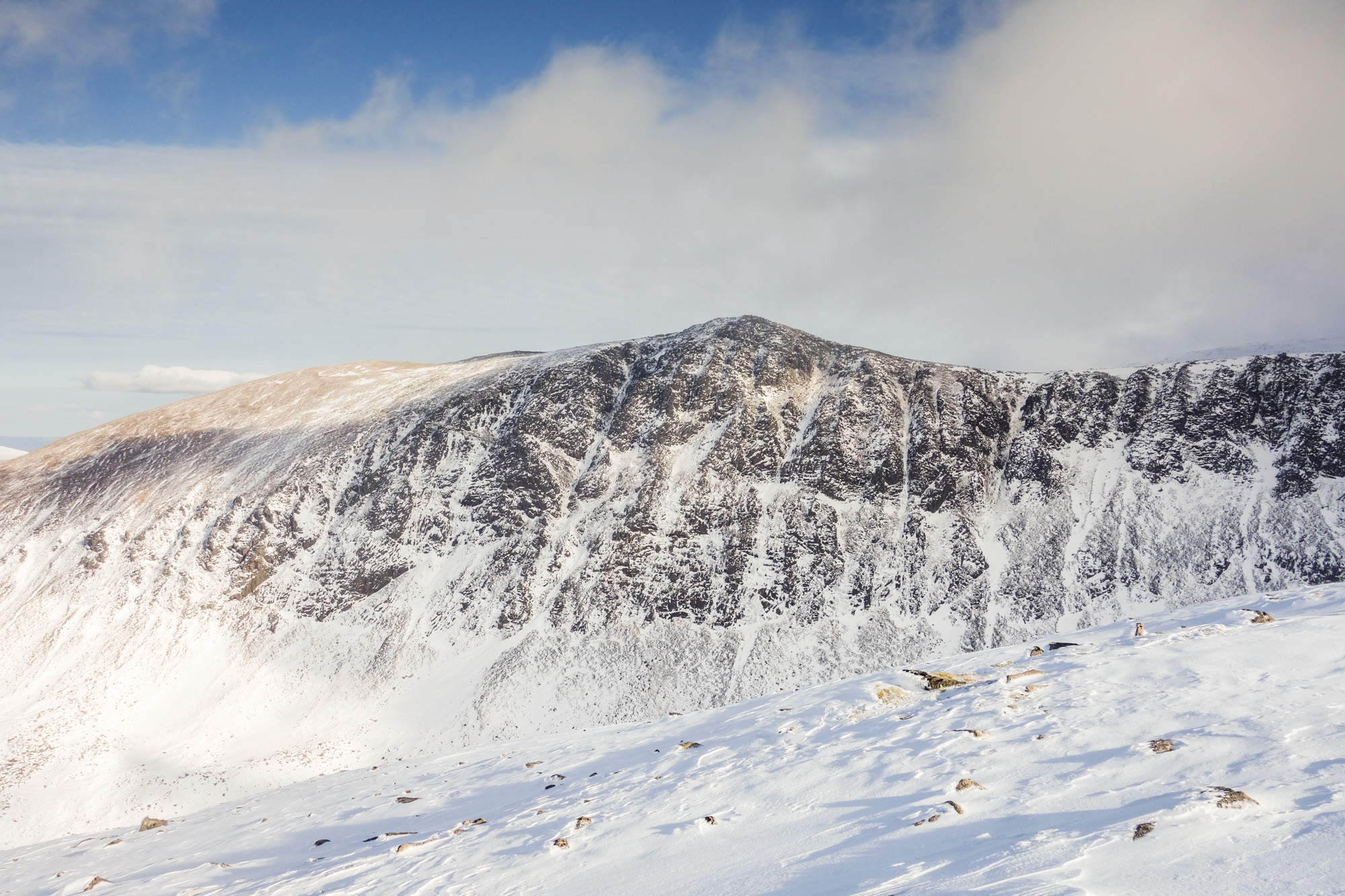 A lean and icy Lurchers Crag as seen from the approach to Braeriach. Window Guly is the wide ice streak left of the obvious Central Gully. Photo credit: Andy Inglis