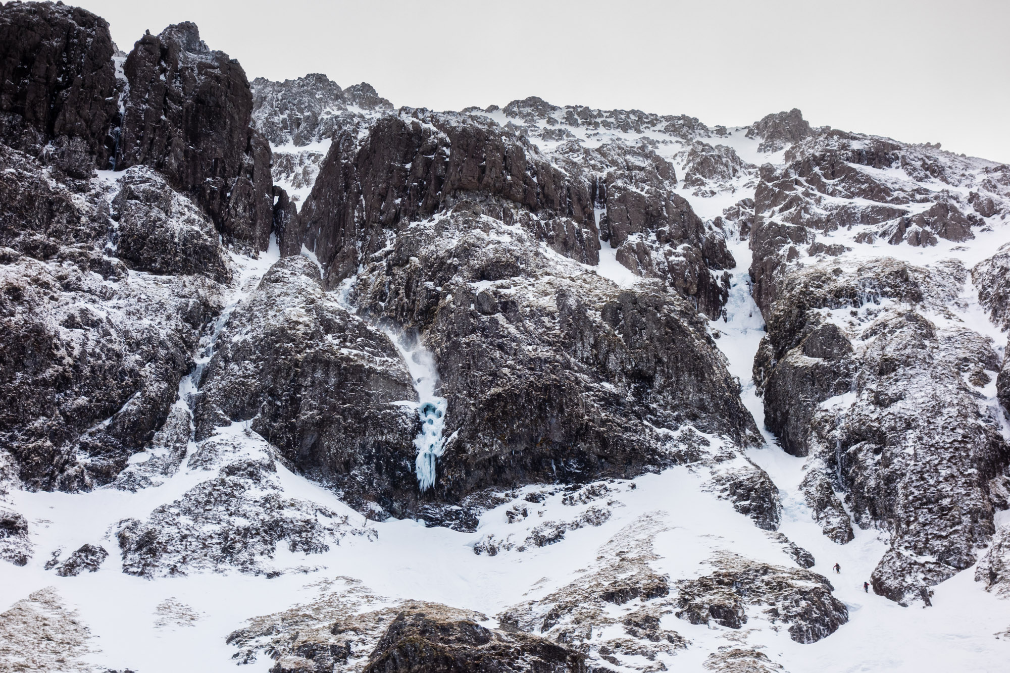 The central horror-show of hanging daggers, ice umbrellas and spindrift is Elliot's Downfall. The team ahead of us starting their solo to the base of crux ice pitch in No6 Gully.